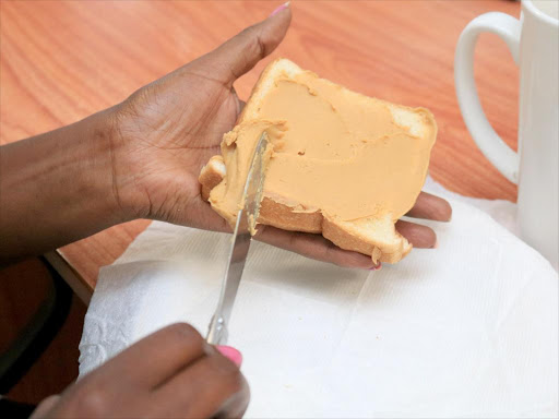 Peanut butter being spread on bread /VICTOR IMBOTO