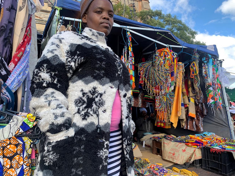 Helingiwe Ngcobo from KZN stands in front of her stall. With the help of her mother, Ngcobo makes beaded accessories and shoes.