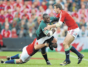 Jamie Heaslip and Tommy Bowe of the Lions tackle Tendai Mtawarira of SA during The British and Irish Lions third Test match at Coca-Cola Park on July 4 2009 in SA. 