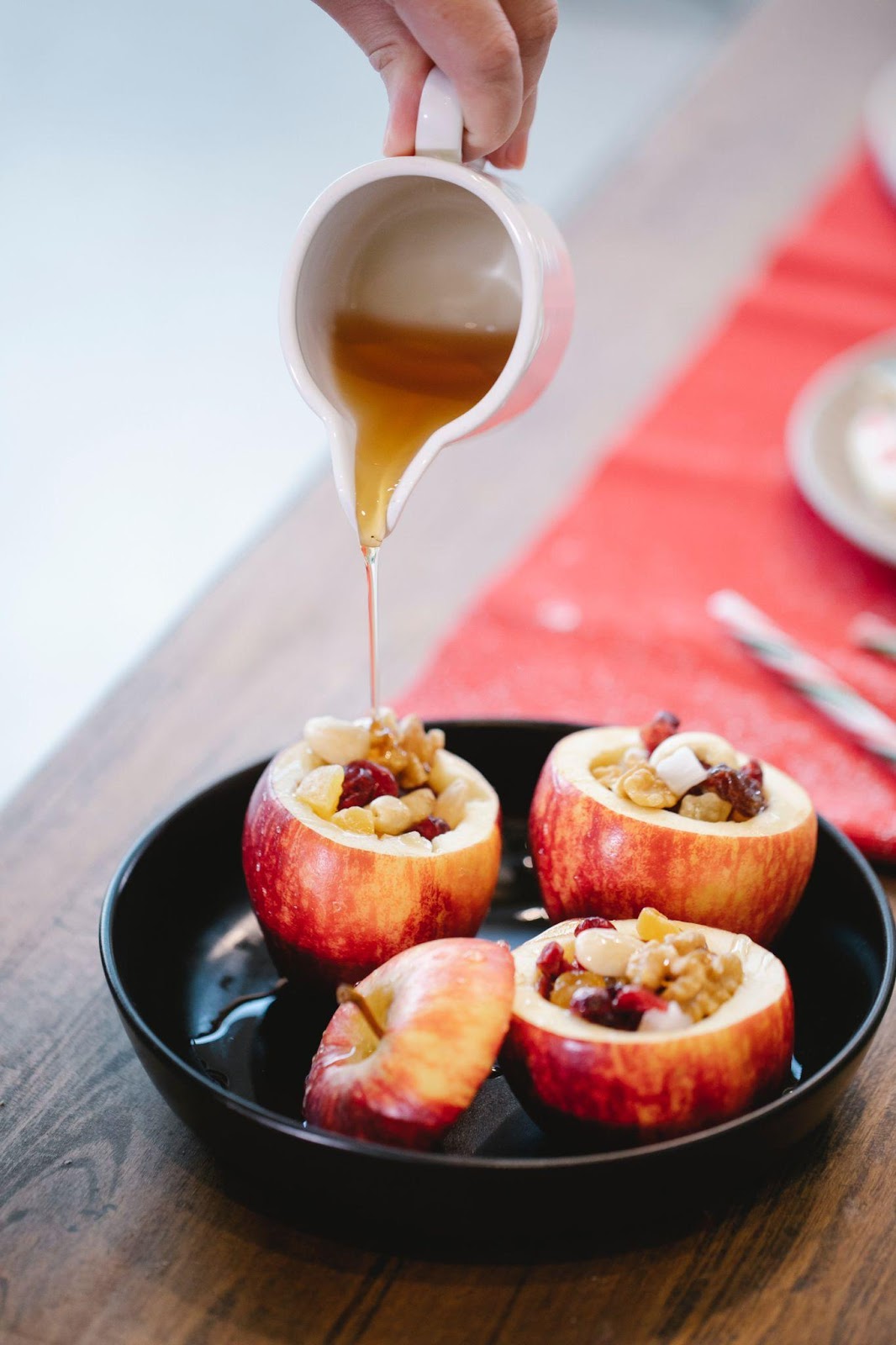 Chef pouring honey on stuffed apple