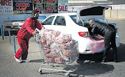 FULL TROLLEY John Xaba loads meat into a car belonging to a restaurant owner in Johannesburg More people are buying meat from wholesalers instead of retailers as it is more cost-effective.