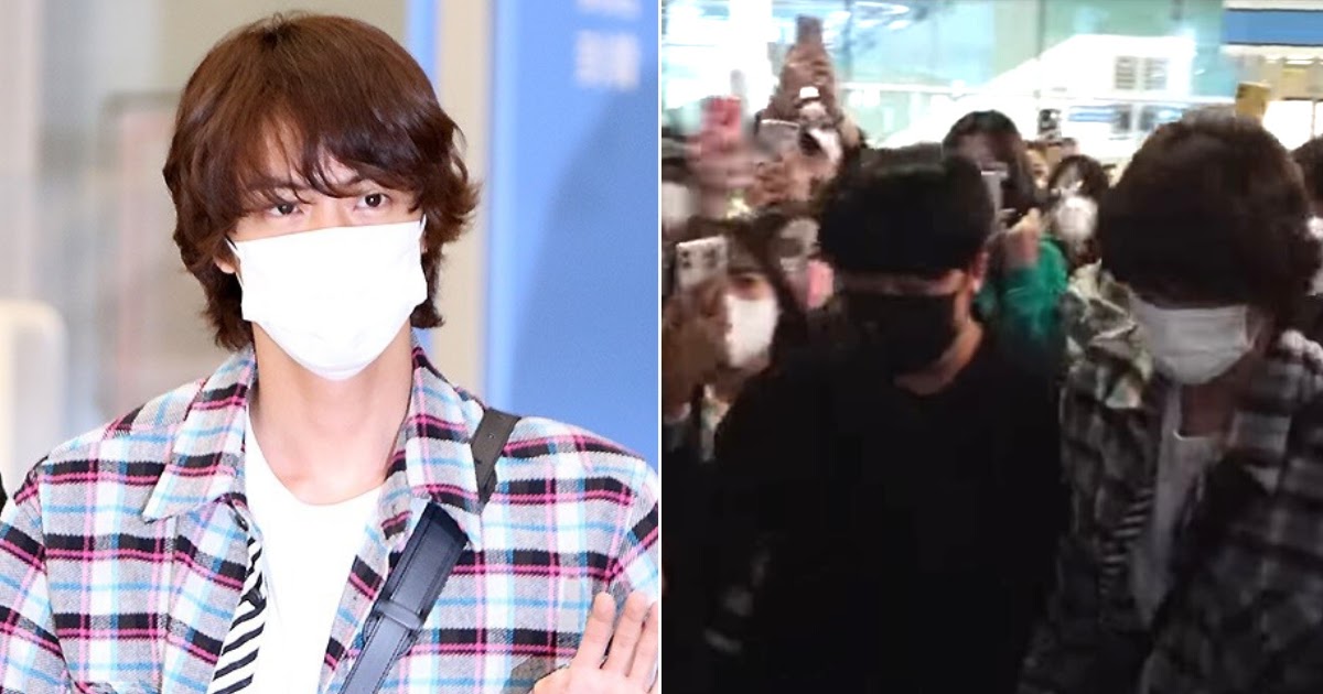 BTS' Jin waves for cameras at airport