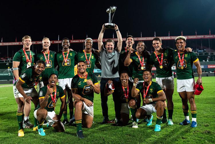 The Blitzboks pose with the trophy after victory in the final against Argentina during the HSBC SVNS on December 3 2023 in Dubai. Picture: MARTIN DOKOUPIL/GETTY IMAGES