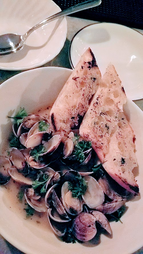 Shipwreck PDX food dish of Steamer Clams with butter, white wine, garlic, chili flakes, curly parsley, Accuardi's Garlic Bread