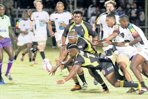 ALL IN REACH: University of Fort Hare flank Zanoxolo Qwele, in the centre, reaches for the ball in their game against the University of KwaZulu-Natal Picture: SILUSAPHO NYANDA