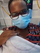 Nosipho Nkantini holds her son, Oyena, for the first time weeks after he was born prematurely by emergency caesarean while his mother was unconscious on ventilator support and fighting for her life due to Covid-19. 