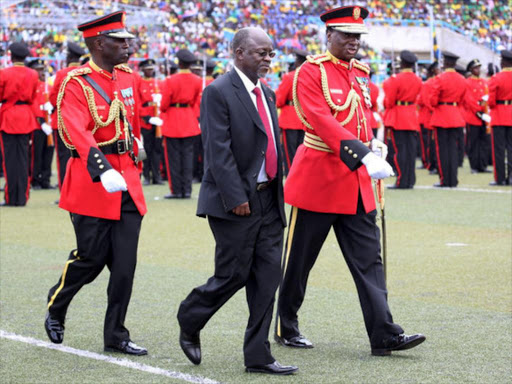 Tanzania's President-elect John Magufuli is escorted after inspecting a Tanzanian military guard of honour during his inauguration ceremony at the Uhuru Stadium in Dar es Salaam, Tanzania November 5, 2015. /REUTERS