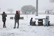 Residents come out to see and play in the snow, 10 July 2023, at Jackson Dam in Alberton, South of Johannesburg.  