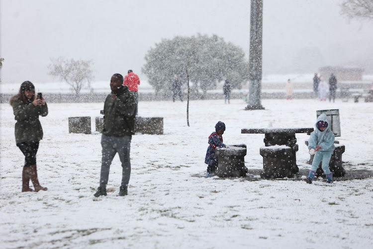 Residents come out to see and play in the snow, 10 July 2023, at Jackson Dam in Alberton, South of Johannesburg.