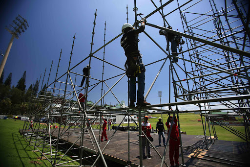 GOING UP: Contractors putting together the main stage at Buffalo Park for the annual Buyel’Ekhaya festival taking place on Sunday Picture: MARK ANDREWS