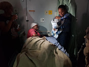 Limpopo health MEC Phophi Ramathuba congratulates a mother who gave birth amid a power outage and storm at Jane Furse Hospital.