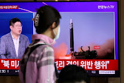 A woman watches a TV broadcasting a news report on North Korea's launch of three missiles including one thought to be an intercontinental ballistic missile (ICBM), in Seoul, South Korea, May 25, 2022.   