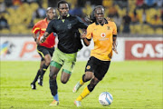 CHASING GAME: Robert Nga'mbi of Platinum Stars, left, and  Reneilwe Letsholonyane of Kaizer Chiefs during their Absa Premiership match  at Royal Bafokeng Stadium in Rustenburg last night photo: Lee Warren/Gallo Images