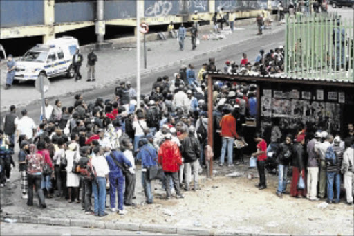 LONG HAUL: Zimbabweans queue for their papers at the Home Affairs Department in Johannesburg Photo: Antonio Muchave