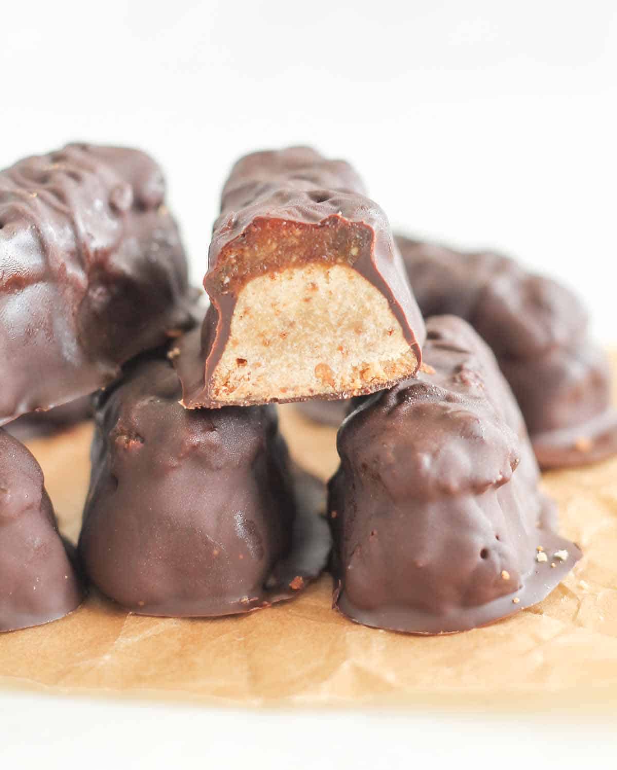 Homemade Twix bars stacked on a white plate.