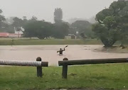 Colin and Joshua Simpkins paddled in the flooded Virginia Circle in Durban North.