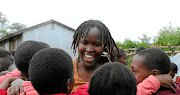 Kakenya Ntaiya with  young girls she prevented from genital mutilation.