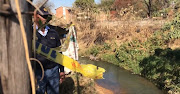 A police officer looks down towards a river where the body of a 13-year-old special needs child was found by her mother.