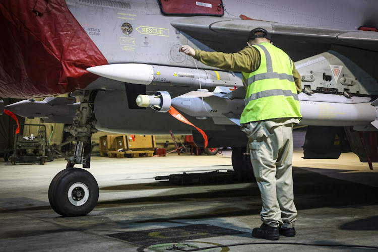 RAF Armourers (Weapon Technicians) prepare a Royal Air Force Typhoon FGR4 for Air Strikes against Houthi military targets in Yemen. Picture: AS1 LEAH JONES