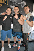 Rowan Campbell, left,  Kevin Lerena,  and  trainer Peter Smith who has made them champions despite the fact that they have no amateur background. 