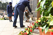 A family member of a slain officer lays down a flower at the national commemoration day for police officers on Sunday.