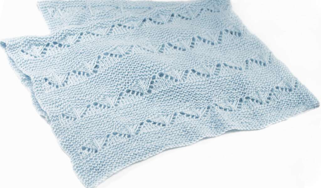 light blue loom knit blanket pattern on white background