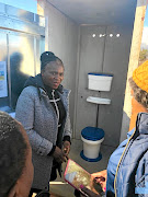 Radzilani explains to a recipient  how the latrine  works.