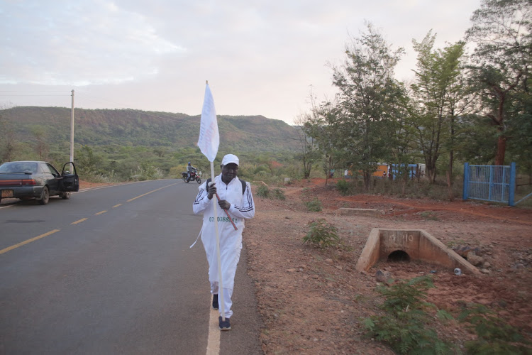 Retired Baringo Chief Joseph Malatit starts his 90km Kabarnet-Eldoret trek to stop cold blood killings on Wednesday.