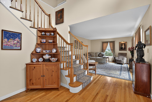 Wooden staircase and corner cabinet in this luxury property for sale in Hamden ($512,000)