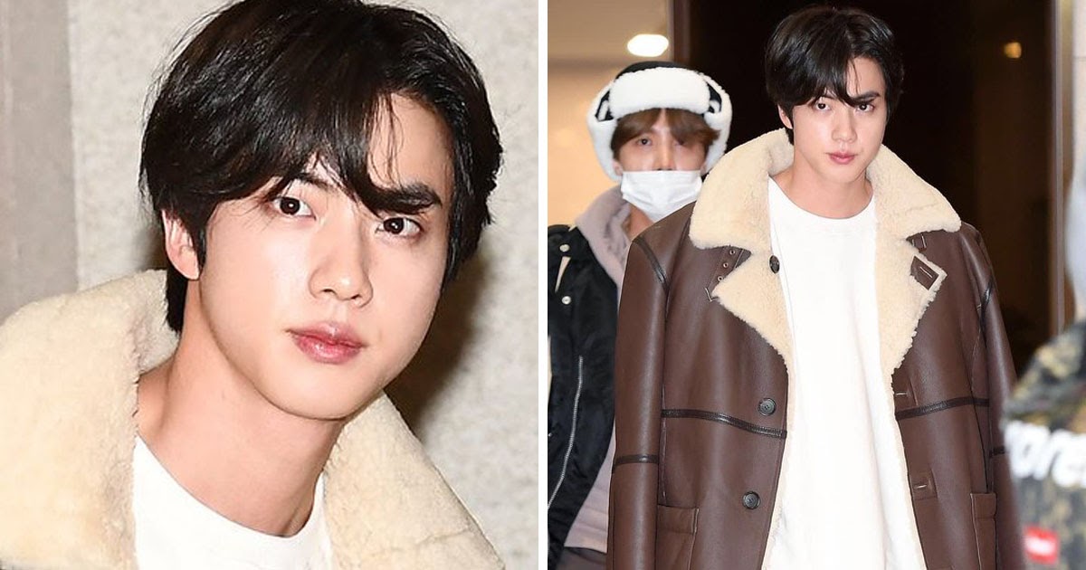 BTS' Jin waves for cameras at airport