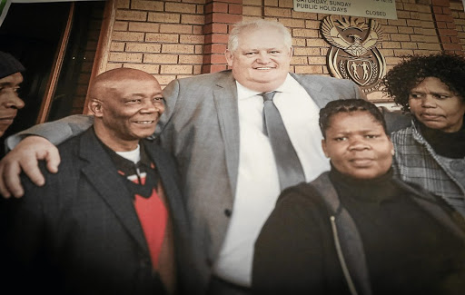 Barney Mokgatle, left, with Angelo Agrizzi, The photograph hangs on a wall of the Barney Mogatle Foundation office.