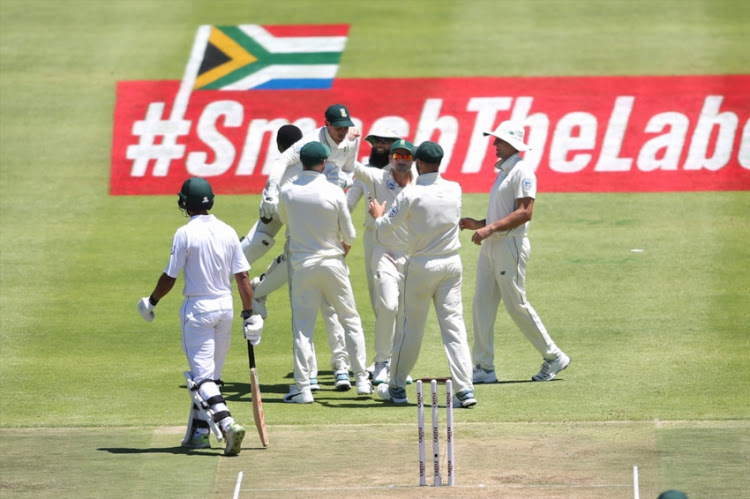 Quinton de Kock of South Africa and Kagiso Rabada of South Africa celebrate getting Shan Masood of Pakistan wicket during day 1 of the 2nd Castle Lager Test match between South Africa and Pakistan at PPC Newlands on January 03, 2019 in Cape Town, South Africa.