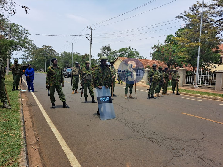 Police block a road few meters to Kisumu State Lodge after the locals protesting high cost of living passed by on March 10, 2023.