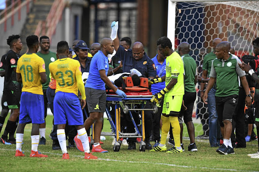 An injured Letlabika is carried away in a stretcher.