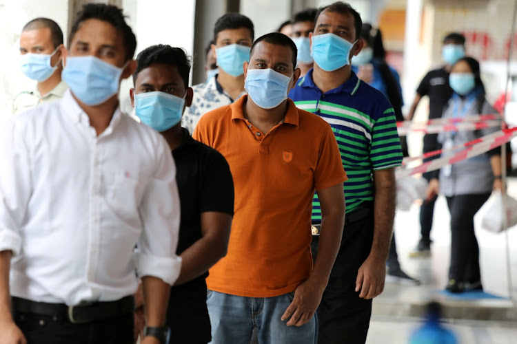 People wait to be tested for Covid-19 outside a clinic in Kajang, Malaysia. File photo.