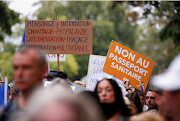 Protesters attend a demonstration against France's restrictions, including a compulsory health pass, to fight the coronavirus disease outbreak, in Paris, France, on August 21 2021. 
