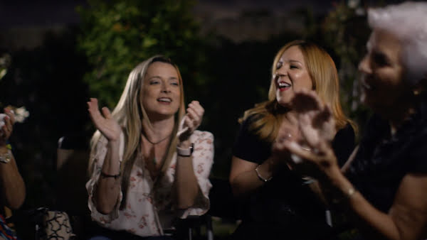 Two women sitting in a circle and clapping