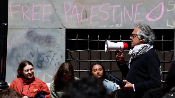 Students listen to a speaker at a protest at Emerson College