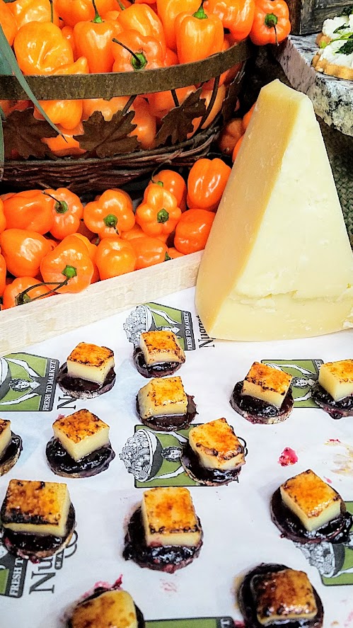 At the California Artisan Cheese Festival 2018 Best Bite Competition, Chris Stone representing Nugget Market Woodland used Lionza fro Fiscalini Cheese Co with some Kelly's marionberry and habanero jelly over an Olympia Provisions chorizo sausage.