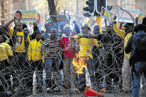 ANC Youth League supporters came out in their numbers last week to demonstrate their support for embattled league leader Julius Malema. Protesters attacked journalists and police and threw bottles and stones at businesses during a day of rioting Picture: ALON SKUY