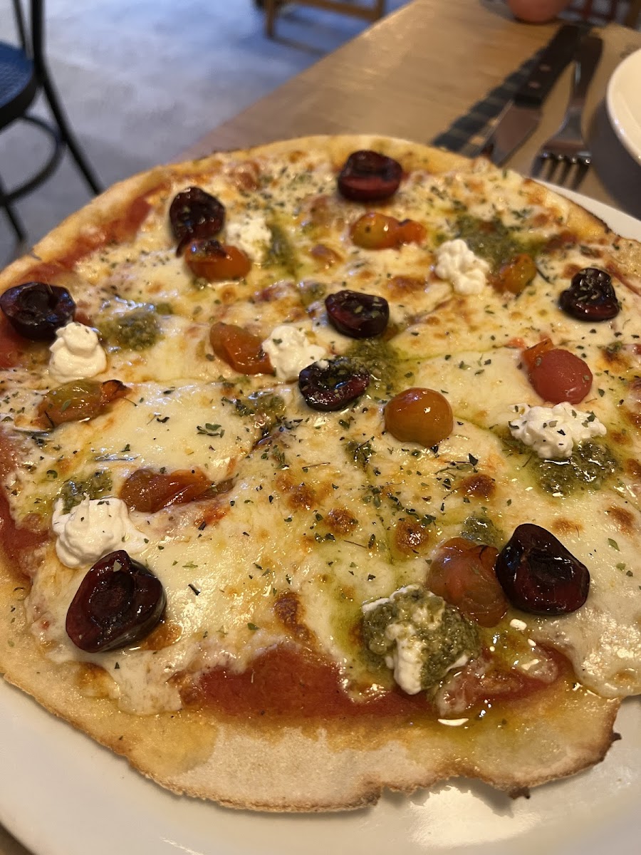 Seasonal cherry pon pizza - had cherry toaotes, cherrries, cheese, pesto and lemon zest. Bery tasty combo of savory and sweet