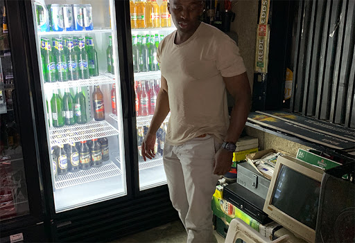 Pub employee next to a refrigerator monitored by Fridgeloc Connected Cooler.