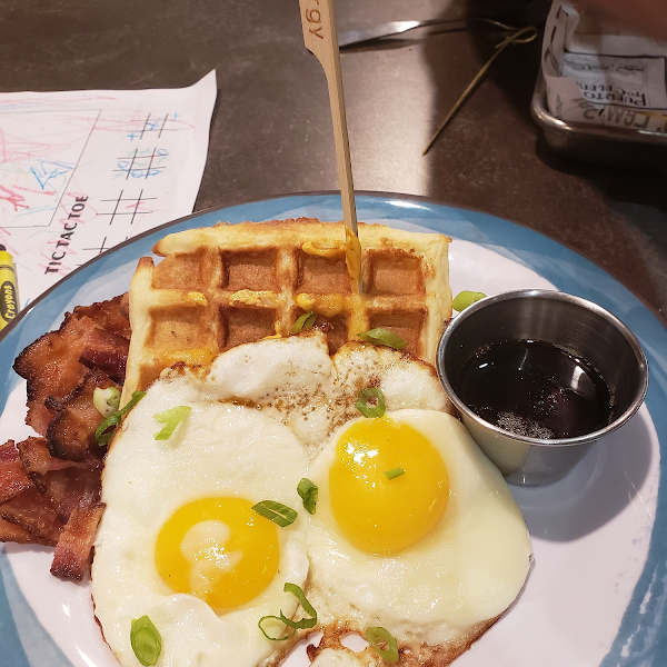 Chicken and waffle with eggs and bacon