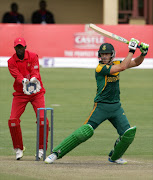 South African batsman Faf du Plessis (R) plays a shot next to wicket keeper Richmond Mutumbami during the 1st ODI match between Zimbabwe and South Africa at Queens Sports Club on August 17, 2014 in Bulawayo, Zimbabwe.