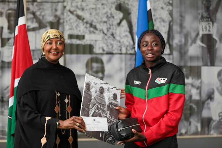 Sports Cabinet secretary Amina Mohammed presents an award to Africa Junior tennis champion Angela Okutoyi at her office last week