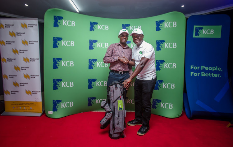 Japheth Achola presents an award to handicap 25 golfer Ondino Abubakar who emerged the overall winner of the 5th leg of the KCB East Africa Golf Tour.