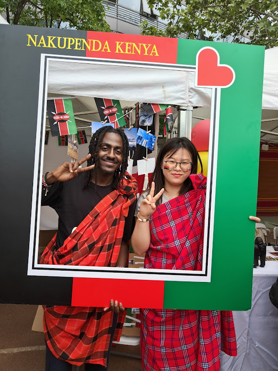 Immanuel Ndile shares a moment with a Chinese collegemate at the 19th World Cultural Carnival in Beijing, China.