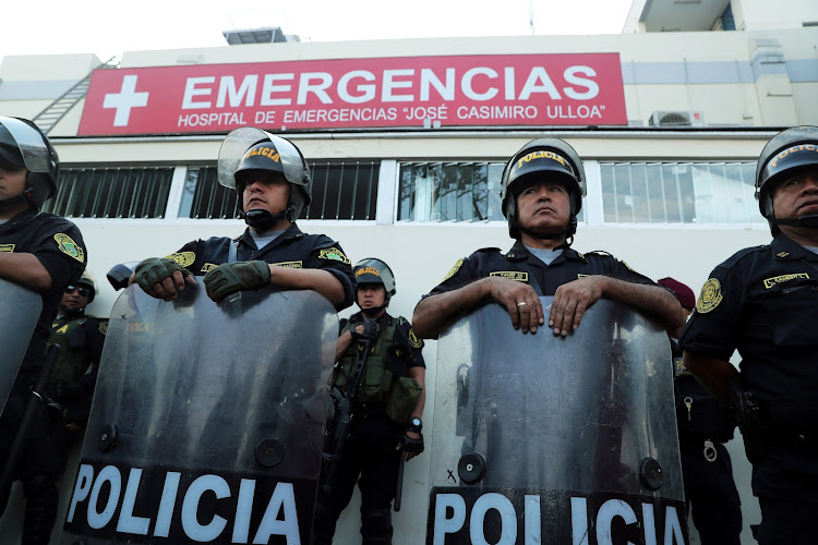 Police stand guard outside a hospital where Peru's former president Alan Garcia was taken after he shot himself, in Lima, Peru, on April 17 2019.