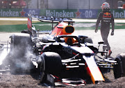 Max Verstappen walks back to the pits after tangling with Lewis Hamilton at the F1 Grand Prix of Italy at Autodromo di Monza on September 12 2021 in Monza, Italy.