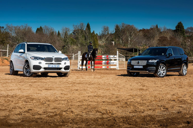 The 2016 BMW X5 xDrive40e (left) and Volvo XC90 T8 Twin Engine (right) enjoy a little horseplay.